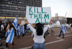 A supporter of Elor Azaria, an Israeli soldier charged with manslaughter after he shot a wounded Palestinian as he lay on the ground in Hebron, holds a placard during a protest calling for his release in Tel Aviv on April 19. (© Baz Ratner / Reuters/REUTERS)